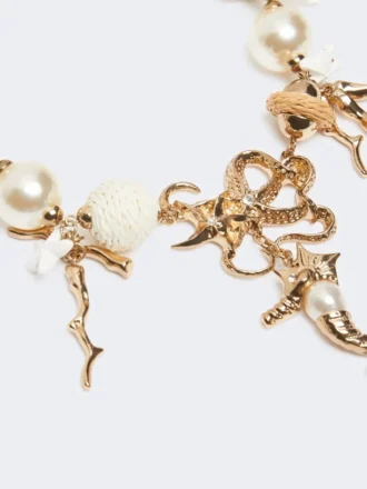 “Abissi” chokerhalsketting van metaal en raffia, goud